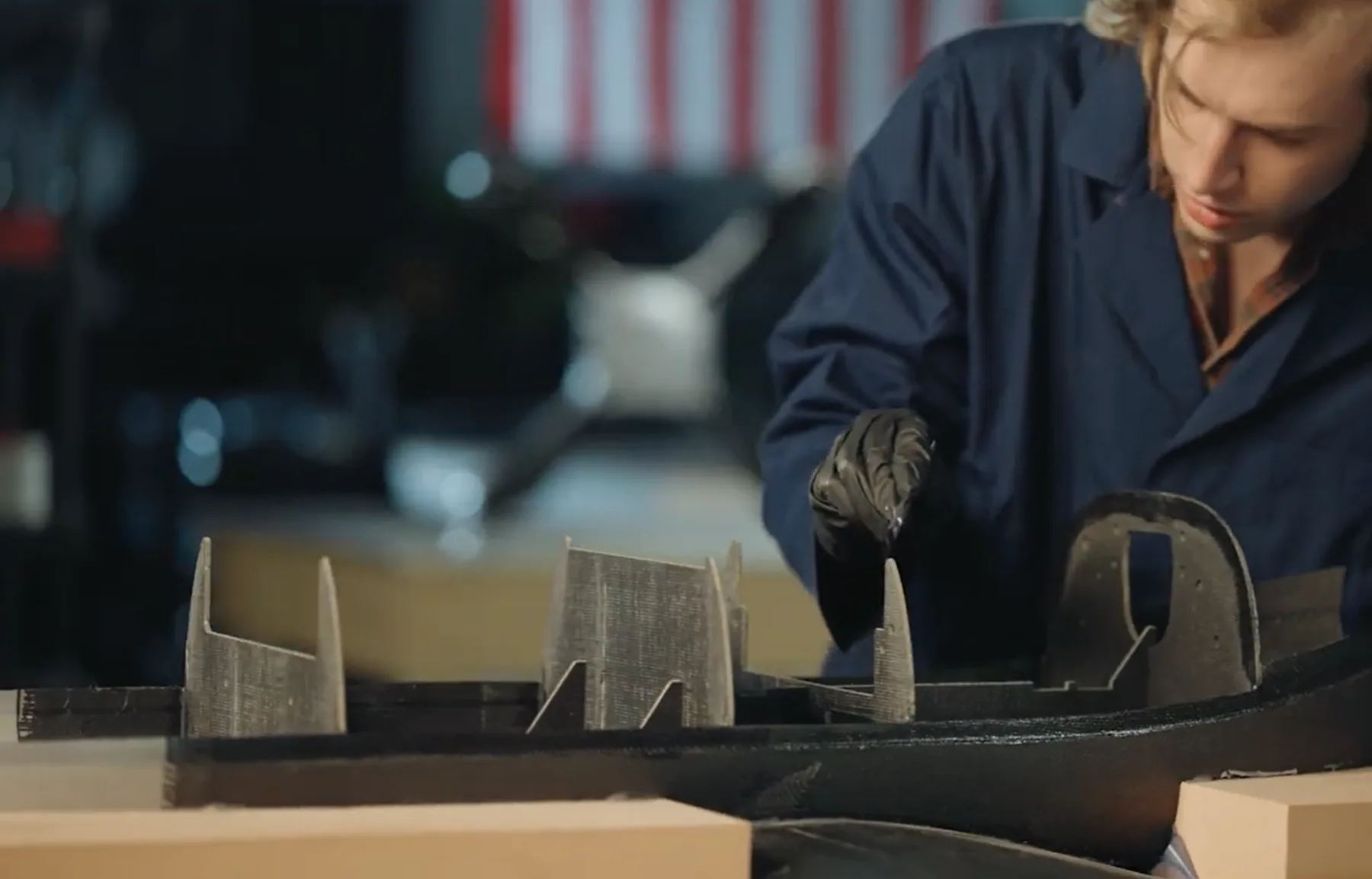 Technician fitting an aircraft structural component in a workshop